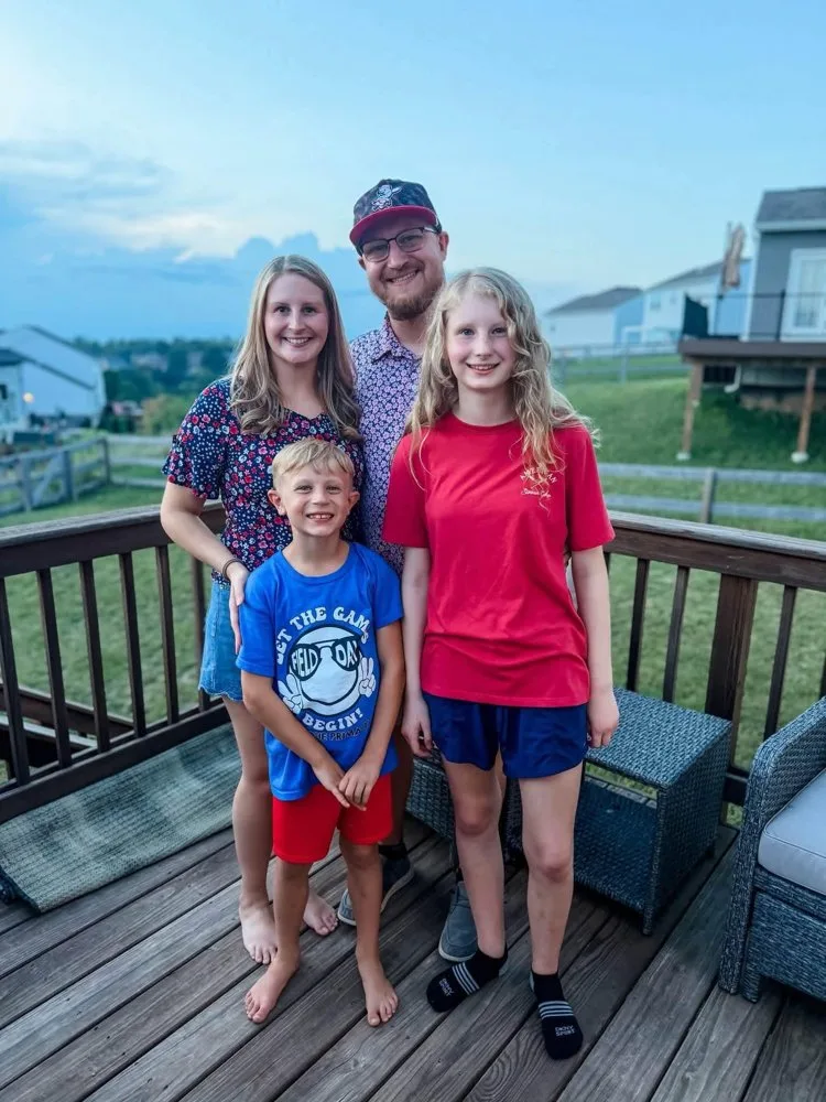 Isaac and Jessica Hardy with their two children on their back deck