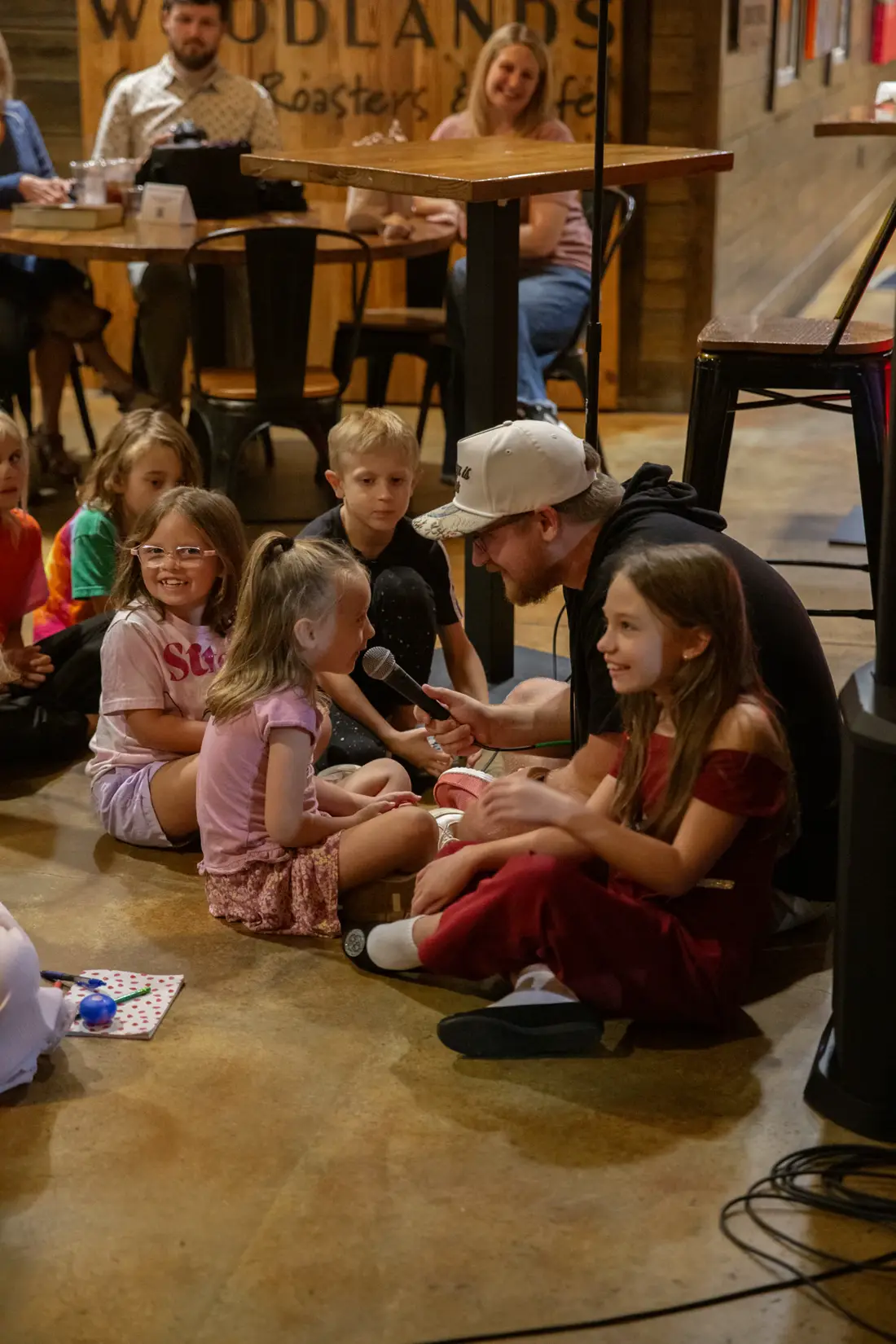 Children gathered around a microphone during the bible lesson